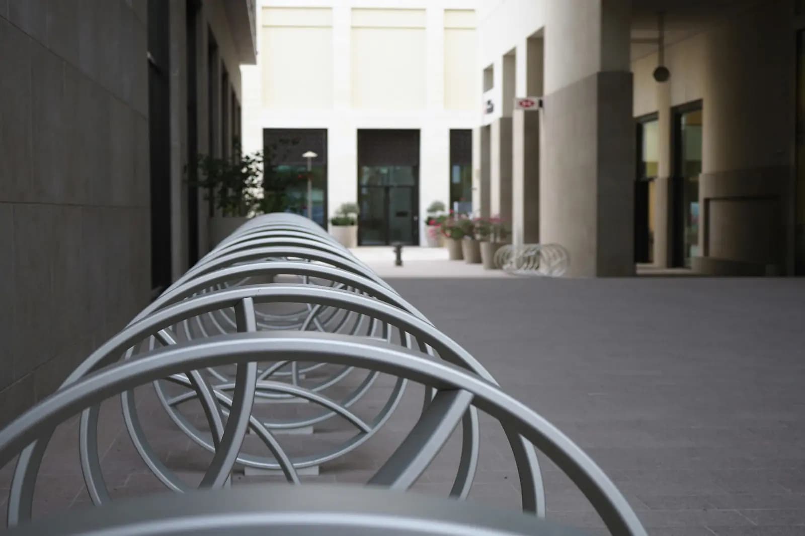 Commercial spiral bike racks installed outside a modern office building in Canada