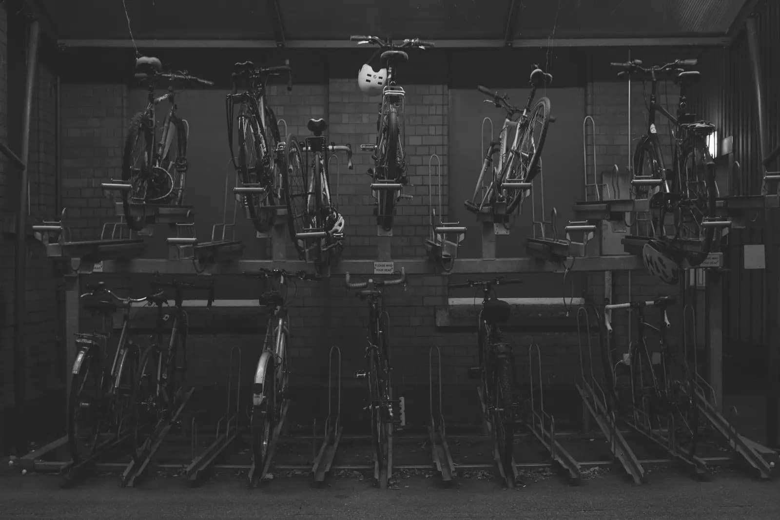 Two-tier bike racks in a multi-residential building covered bike parking area in Canada