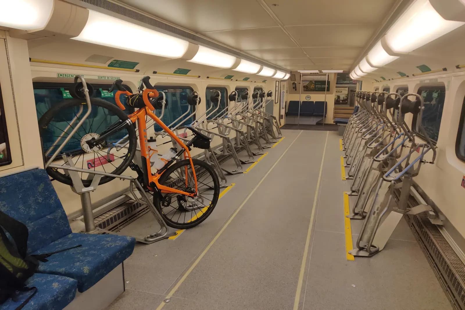 Bike racks inside a Canadian commuter train car with vertical bicycle parking stands